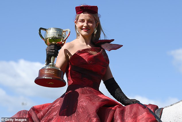 Michelle Payne - the only female jockey to win the cup after her victory in 2015 - presents the trophy at Flemington last Monday