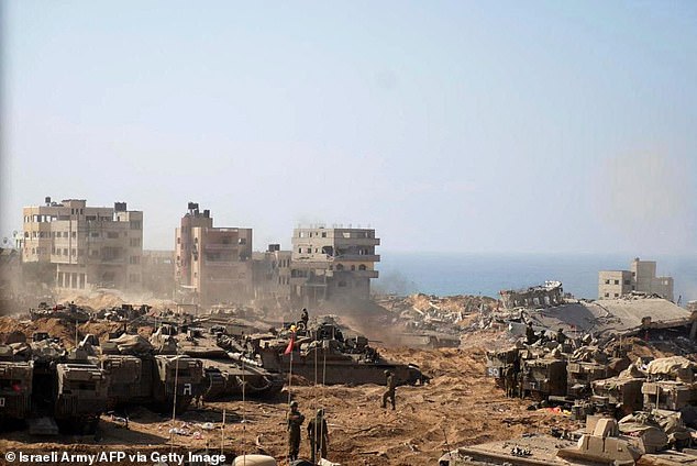 This reaching photo, released by the Israeli military on November 5, 2023, shows Israeli tanks and soldiers stationed at a location in the northern Gaza Strip as fighting between Israel and the Palestinian Hamas movement continues.