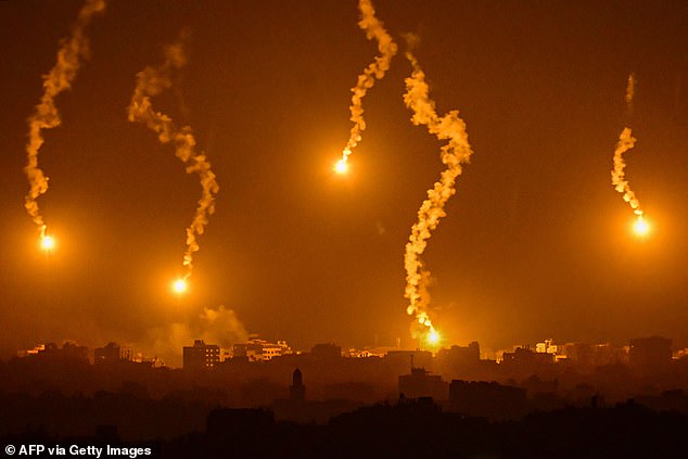 This photo, taken from a position near Sderot along Israel's border with the Gaza Strip on November 5, 2023, shows flares dropped by Israeli forces over the Palestinian enclave amid ongoing fighting between Israel and the Palestinian Hamas movement.