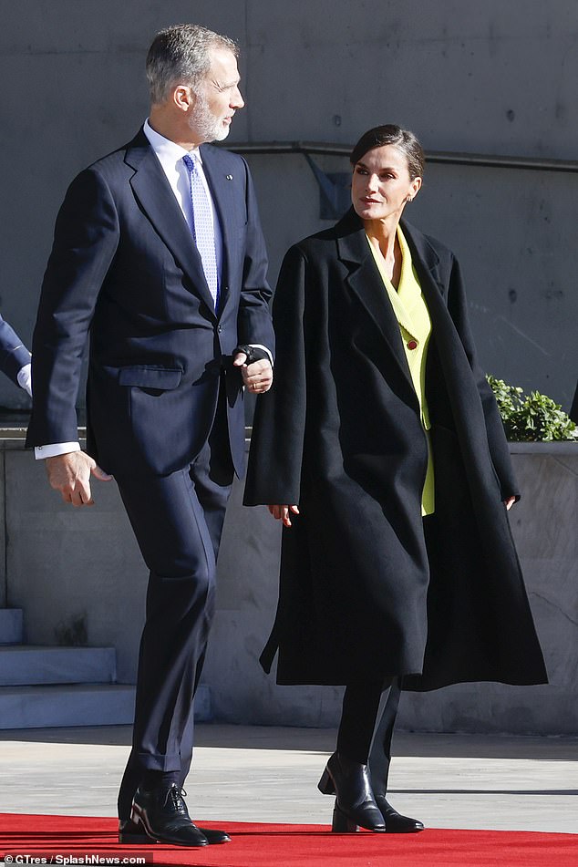 The mother of two was the epitome of style in a tailored black wool coat, black cropped trousers and black chunky leather boots