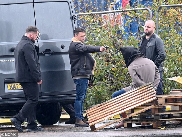 Wow!  Photos from the dramatic scenes show Damon standing in a parking lot with his accomplice as he violently waves a gun around