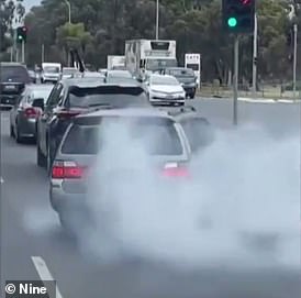 A driver's car has been seized 28 days after he was caught causing a burnout by an unmarked police car in front of him (above)