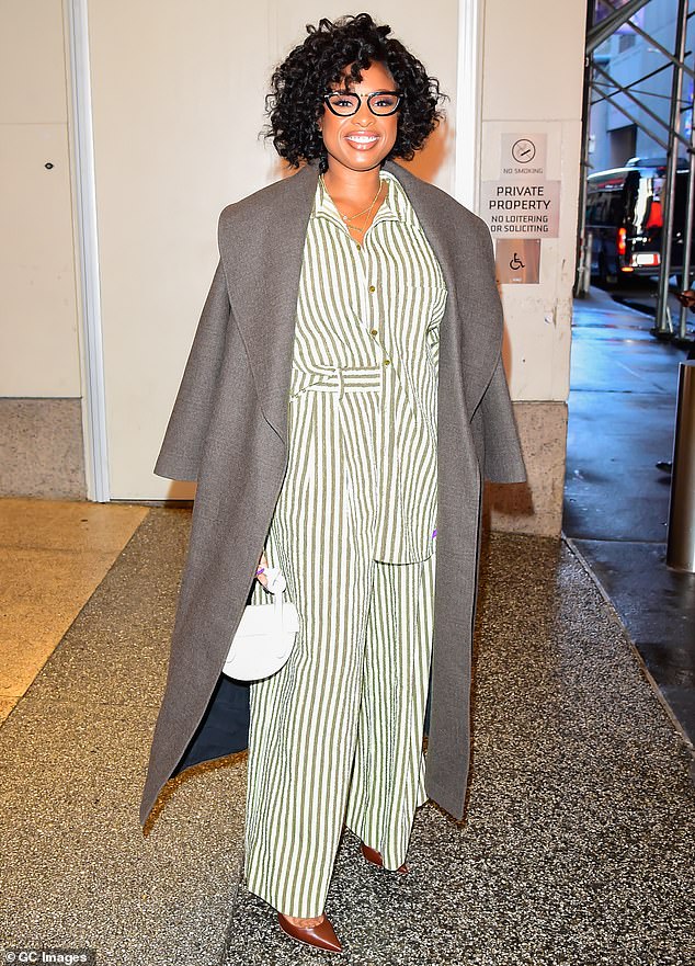 Staying cozy: The artist, who recently dazzled attendees at a charity event in Las Vegas, wore a striped green wide-leg jumpsuit with long sleeves that contrasted well with her dark gray trench coat