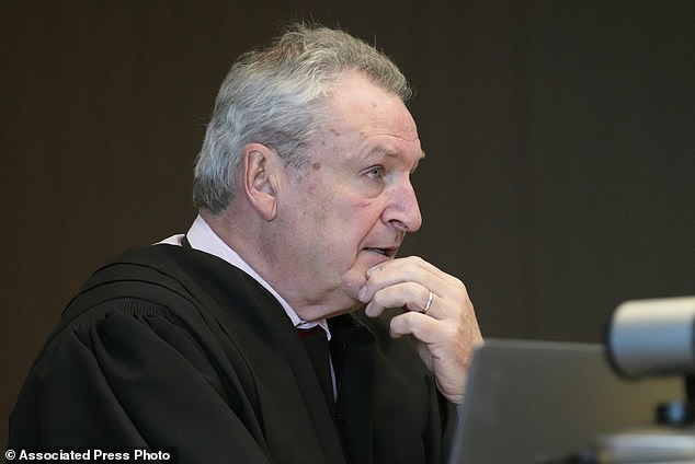 Judge George D. Strickland listens to Robert Crimo Jr.'s attorney, George Gomez, during an appearance Friday at the Lake County Courthouse