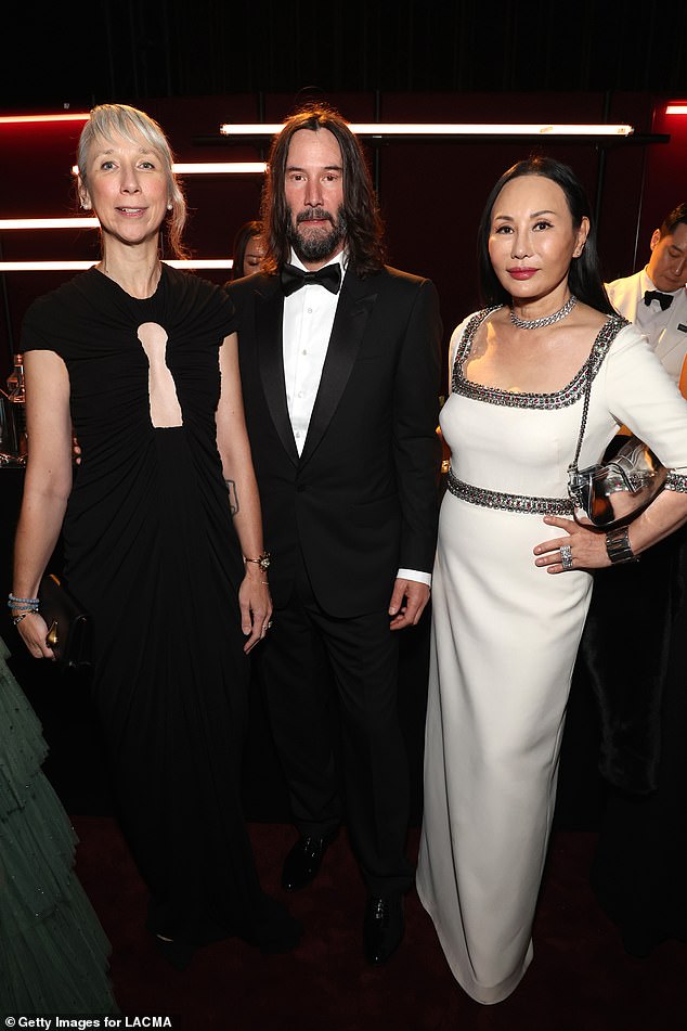 With a beautiful friend: The couple posed with LACMA Art + Film Gala co-chair Eva Chow, who wore a white and crystal Gucci dress with her hair pulled back