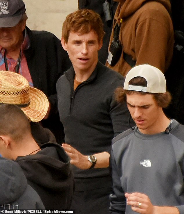 Busy: The Oscar winner could be seen chatting with the crew before jumping behind the wheel of a swanky sports car for a complex action scene