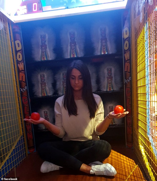 One photo shows her posing in a carnival-style cage called Down With The Clowns while holding two balls, apparently inviting people to take potshots at her