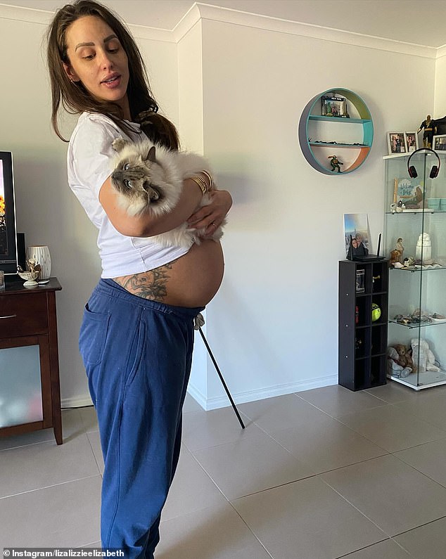 Photos showed Elizabeth cradling her cat as she stood in her apartment and posing with her husband Alexander Vega