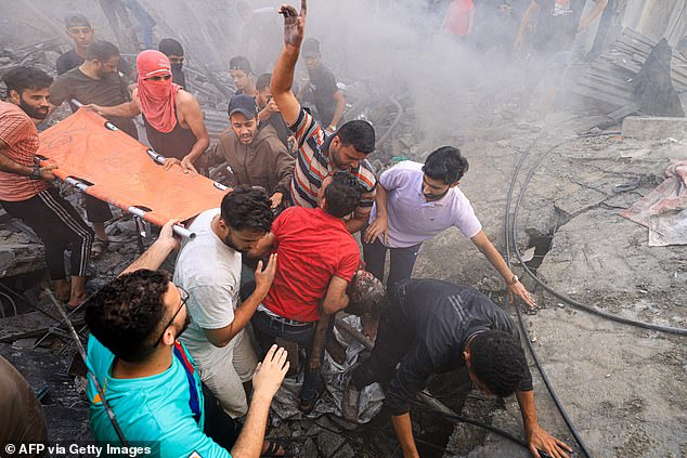 Palestinians recover the body of a child from the rubble of a building, in Khan Yunis on November 6, 2023