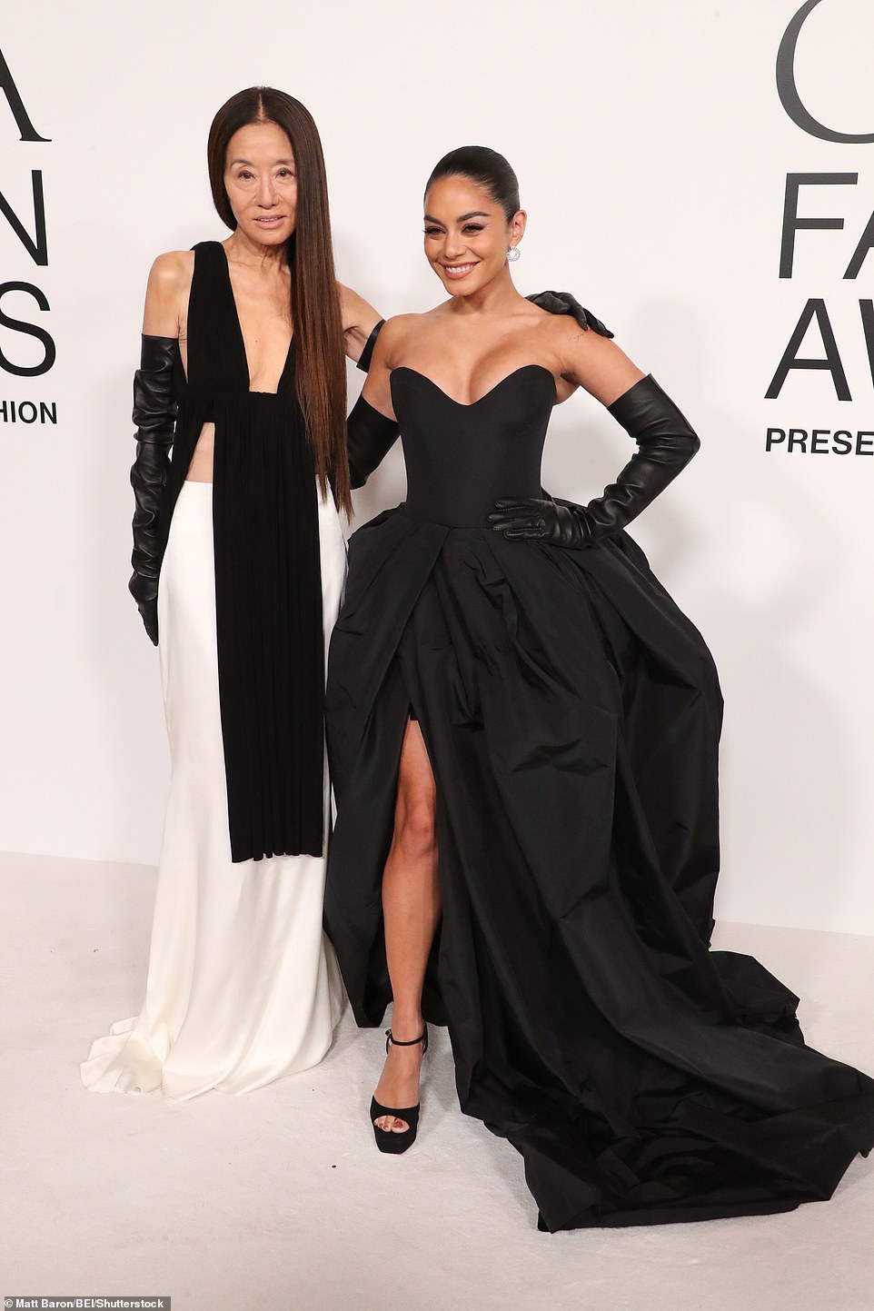 Posing for a moment: At the event, she mingled with Wang, who wore a sleeveless black top with side slits and a long white skirt