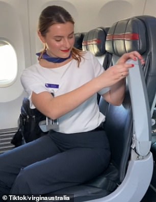 The flight attendant revealed that the button, located in the hinge of the armrest, can be pressed to bring the armrest upright