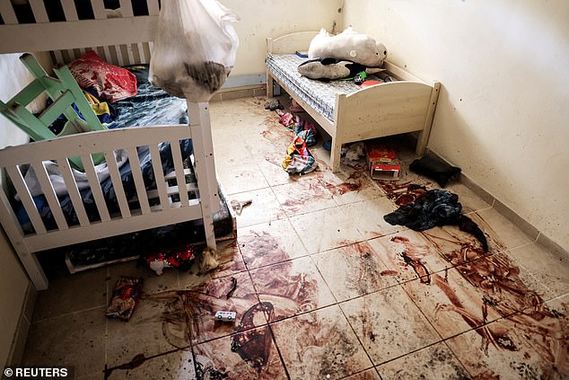 Children's toys and personal items lie on the blood-stained floor of a child's bedroom, following a deadly infiltration by Hamas gunmen from the Gaza Strip in Kibbutz Beeri