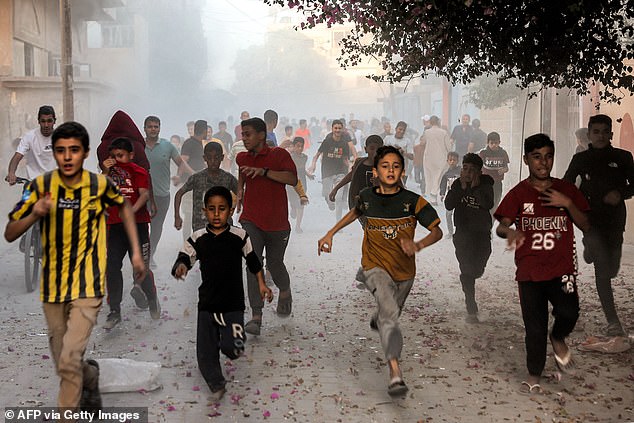 Palestinian children are seen fleeing the Israeli bombardment of Rafah, located in the southern Gaza Strip, on Monday amid ongoing fighting between Israel and Hamas