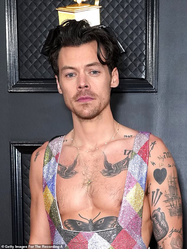 As he was: Harry's fans have a meltdown amid claims he has shaved off his famous locks (pictured in February)
