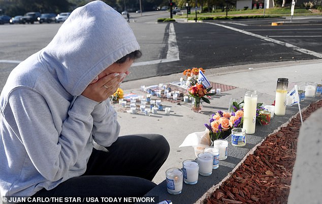 Avia Jacobs, of Westlake Village, cries Tuesday, Nov. 7, 2023, at the Shell gas station at the corner of Thousand Oaks and Westlake Boulevard, where Paul Kessler was injured two days earlier