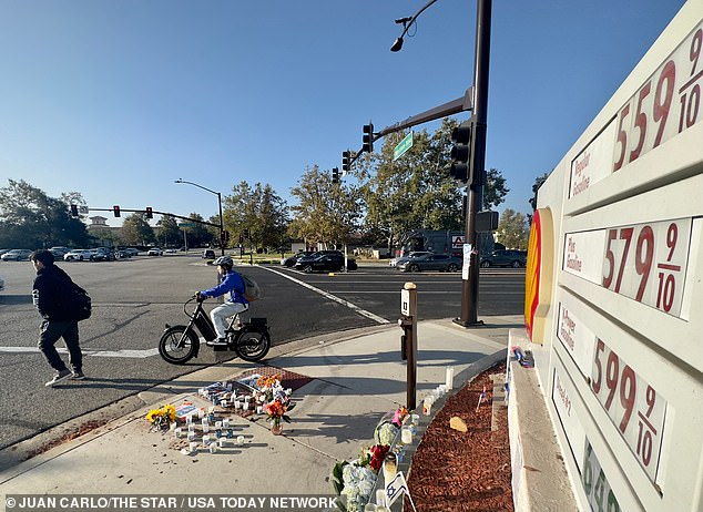 A memorial of flowers and candles stands outside the Shell gas station in Thousand Oaks Tuesday morning.  It was the site of a protest Sunday in which a Jewish man was injured and fell during an altercation.  The man, Paul Kessler, died Monday.