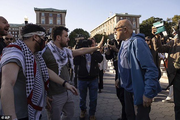 Pro-Palestinian protesters hold back a pro-Israel demonstrator during a protest at Columbia University