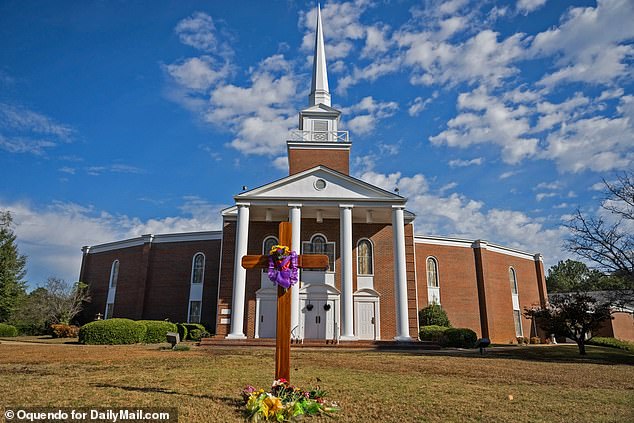 Affected worshipers left floral tributes at the base of a cross outside the First Baptist Church of Phoenix City, Alabama, on Sunday