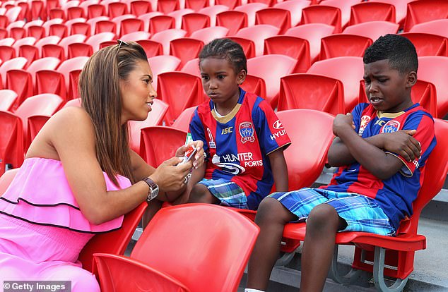 The next Heskey generation (Reigan centre, Jaden right) is pictured with Tagoe in 2012, while their father played for Australian side Newcastle Jets towards the end of his career.