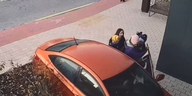 Female passersby can be seen rushing to help as the car hits the wall of an apartment building and stops at the end of the video.