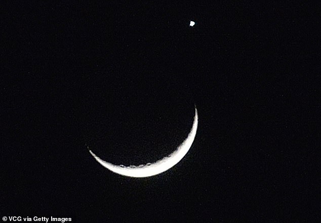 The planet Venus and the crescent moon are pictured on March 24, 2023 in Shenyang, Liaoning Province, China