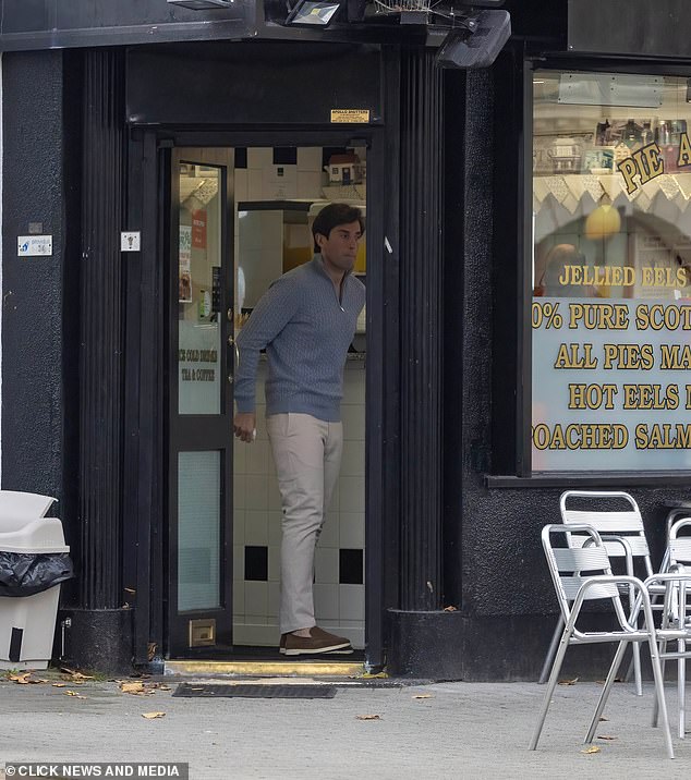 Favorite spot: James, dressed in a blue jumper, looked somber as he picked up his comfort food from the pie and mash shop