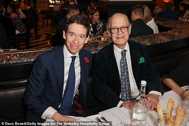 Royal photographer Hugo Burnand was also photographed at the glitzy event, as was former Tory MP Rory Stewart (pictured left of Sir John Standing)