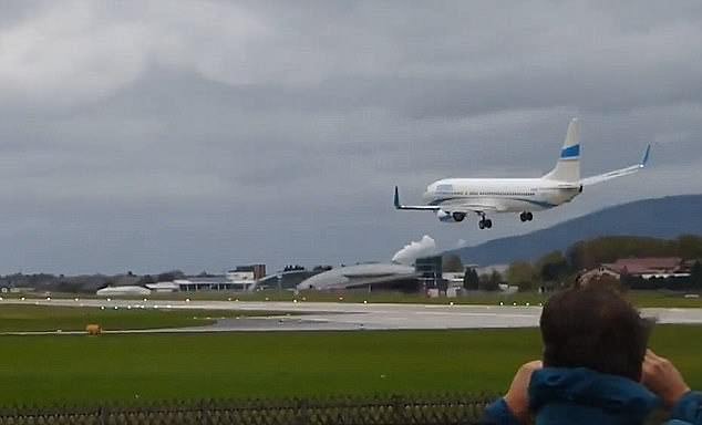 A plane tries to stabilize as it attempts to land at Salzburg Airport in Austria