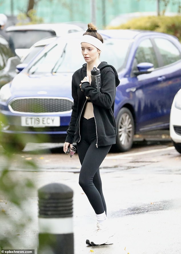 Sporty: The brunette beauty donned a black gym clothes set, paired with white socks and sneakers