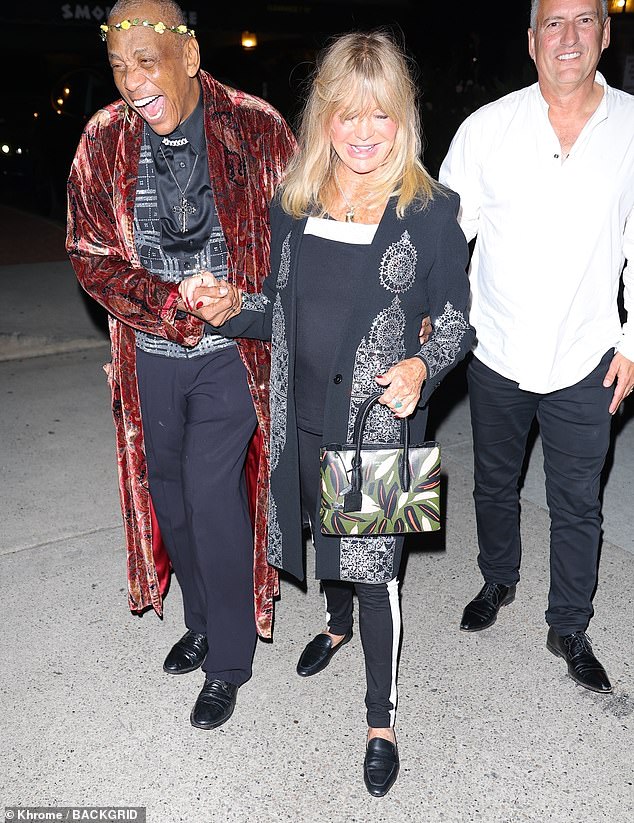 Chic: Actress Goldie looked chic in a black and white top, jacket and trousers with black and silver pattern, paired with brogues