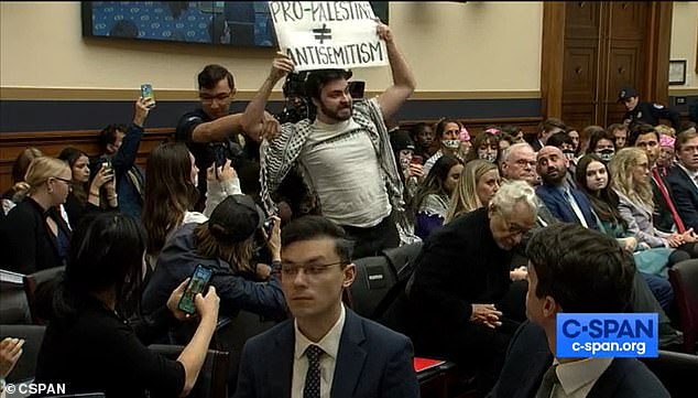 A male protester holding up a 