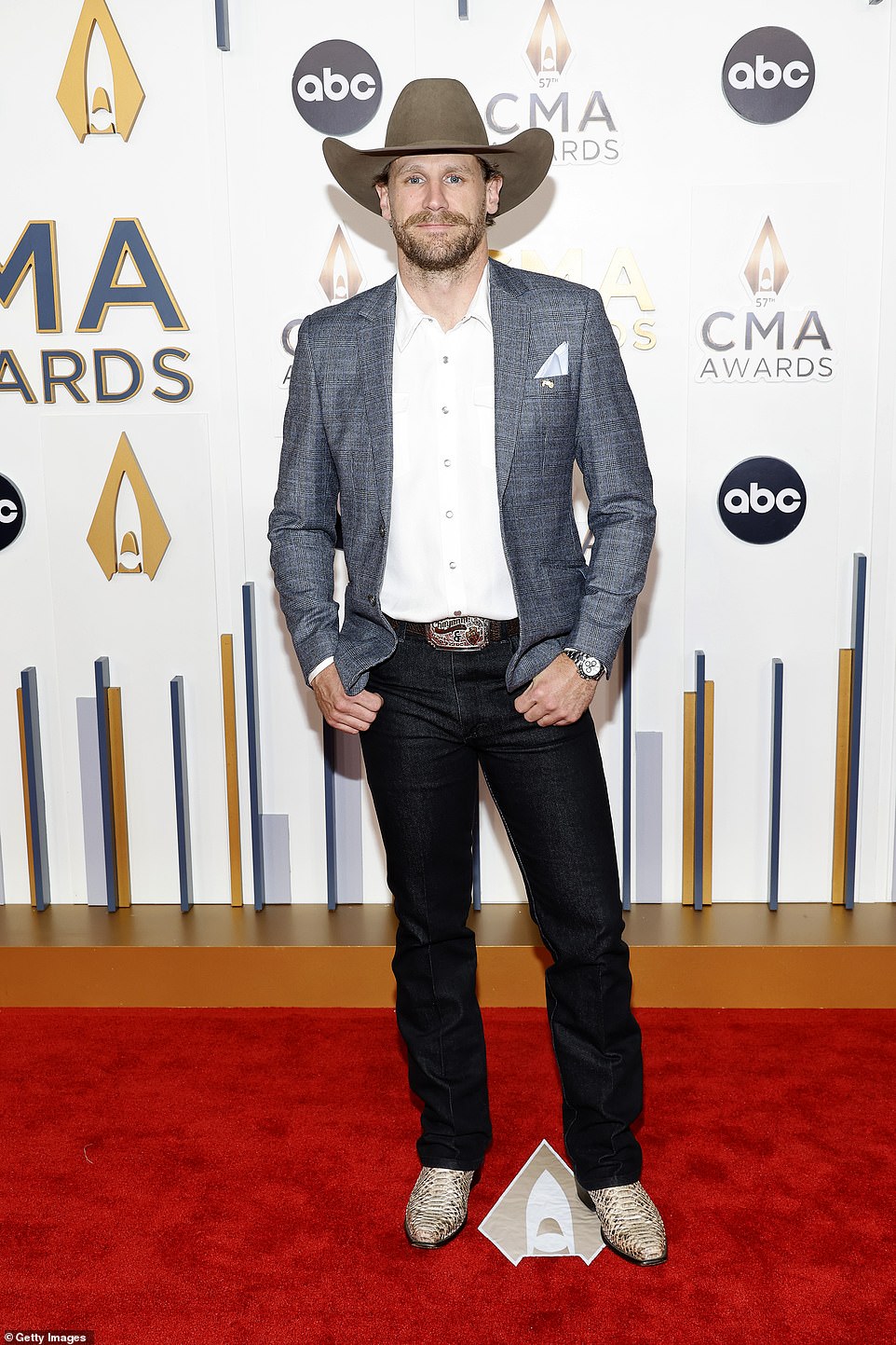 Fully dressed: Chase Rice exuded confidence as he posed for photos in a charcoal gray jacket, dark-wash jeans and alligator boots