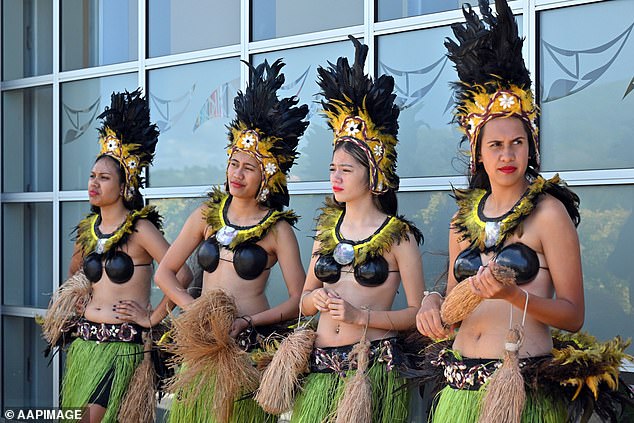 Locals in traditional costume wait to greet Australian Prime Minister Anthony Albanese