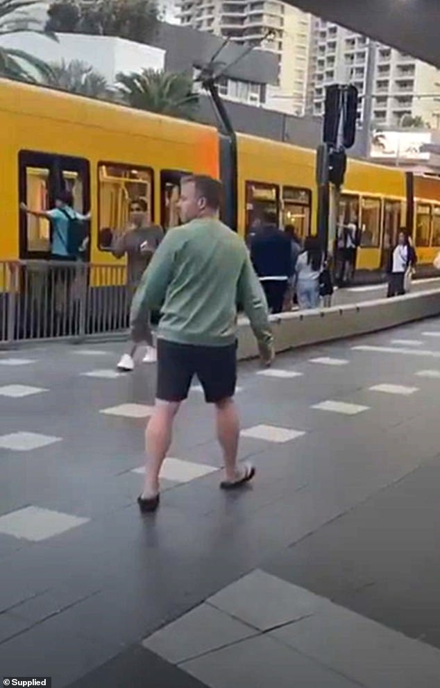 Stunned onlookers watched as the two teenagers (pictured) performed the dangerous stunt as the tram passed through a station