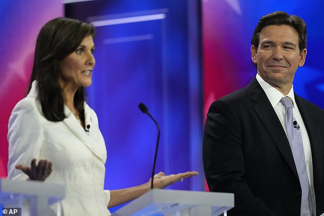 Florida Governor Ron DeSantis (right) offers a look at the GOP's main rival, the former UN ambassador.  Nikki Haley (left) during Wednesday night's third Republican primary debate - in which viewers sifted through his choice of tie and lack of an American flag pin