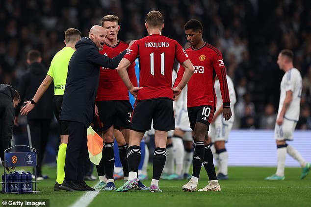 Erik ten Hag talks to his players while a medical emergency occurs in the audience