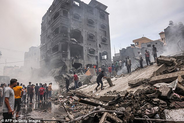 Palestinians search for survivors after an Israeli airstrike on buildings in the Jabalia refugee camp in the Gaza Strip