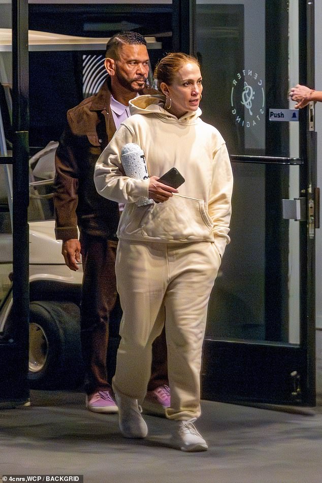 Comfortable: The multi-hyphenate, 54, looked comfortable in a loose pale yellow sweatsuit and white lace-up shoes