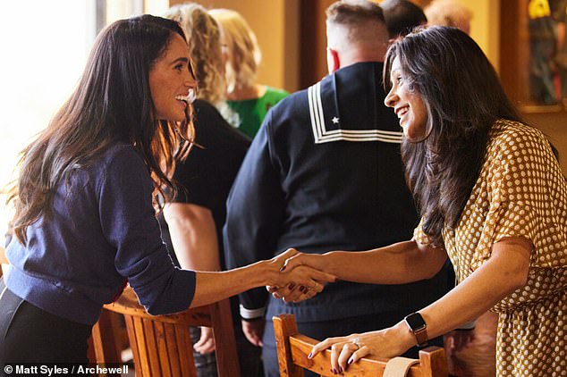 The Duchess of Sussex, wearing a $1,490 Carolina Herrera poppy vest, is seen at Camp Pendleton in California on Wednesday