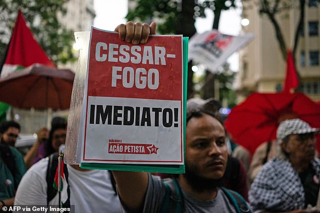 People hold a demonstration in support of the Palestinian people, organized by the Committee of Solidarity with the Palestinian People, in front of the U.S. Embassy in Rio de Janeiro, Brazil, on October 31.