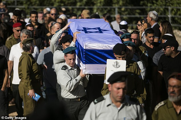 Family and friends attend Wednesday's funeral of fallen Israeli soldier Ya'akov Ozeri, who was killed near Mount Meron in Meron, Israel