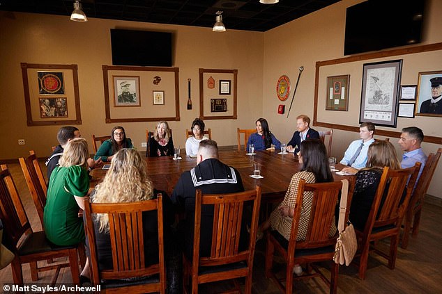 The pair were pictured with about a dozen people at a discussion table learning about the work of Operation Bigs, a mentoring program established in 2004, according to Archewell.