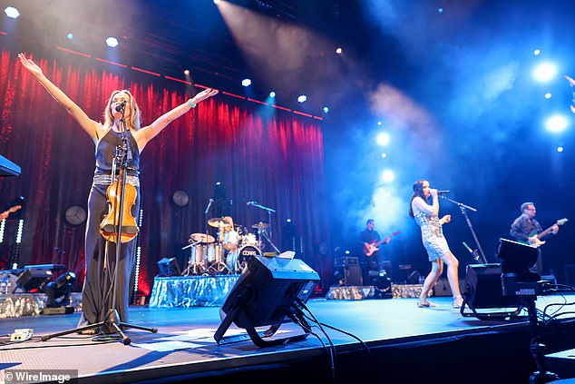 Stunning: Violinist Sharon exuded elegance in a long black halter dress, accented with a silver sequin belt for a touch of sparkle