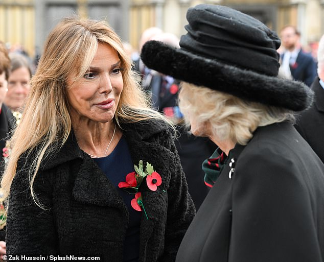 Here you are!  The star, 55, swapped her signature sassy look for an understated sheath dress and chic faux fur coat as she greeted the wife of King Charles, 76