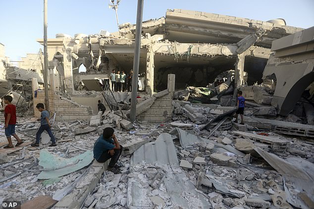 Palestinians inspect the damage of a destroyed mosque after an Israeli airstrike in the Khan Younis refugee camp, southern Gaza Strip, Wednesday, November 8, 2023