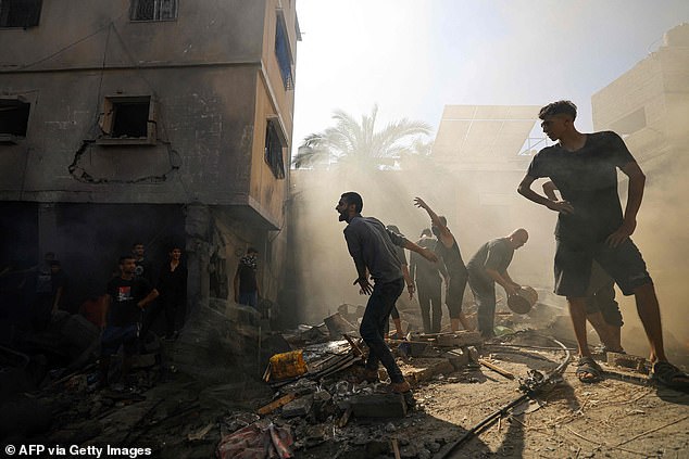 Palestinians react while checking the rubble of a building in Khan Yunis on November 6, 2023