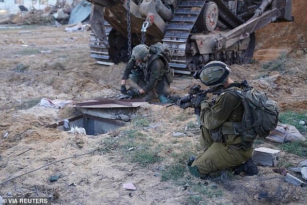 Israeli soldiers inspect the entrance to what they believe is a tunnel used by militants from the Palestinian Islamist group Hamas