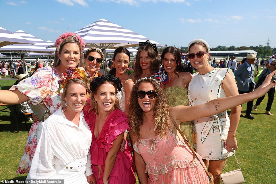 Racegoers let their hair down and enjoyed a few drinks in the sun on Thursday as Oaks Day - or Ladies Day - was in full swing