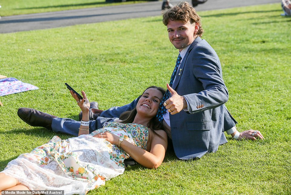 It's a thumbs up from the man in the suit, who politely offers his girlfriend a place to rest her head