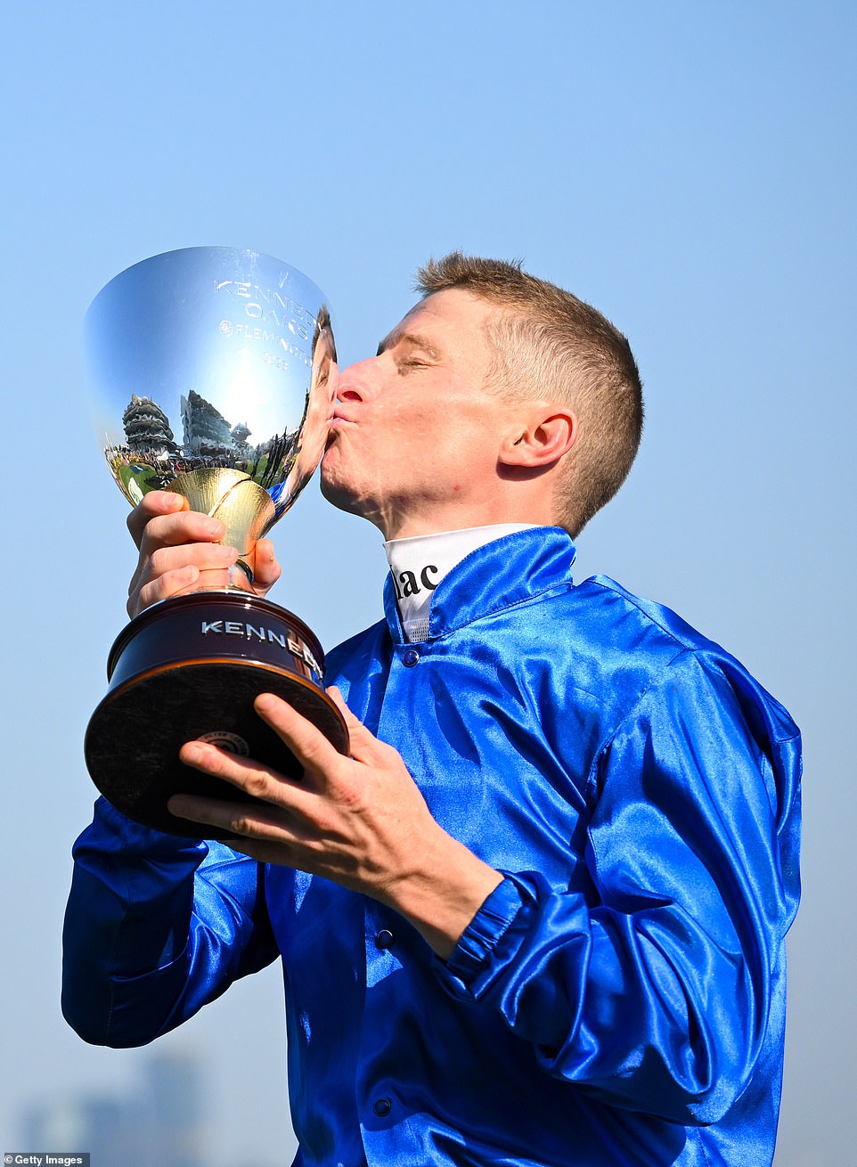 James McDonald kisses the trophy after winning the Kennedy Oaks at Flemington with Zardozi